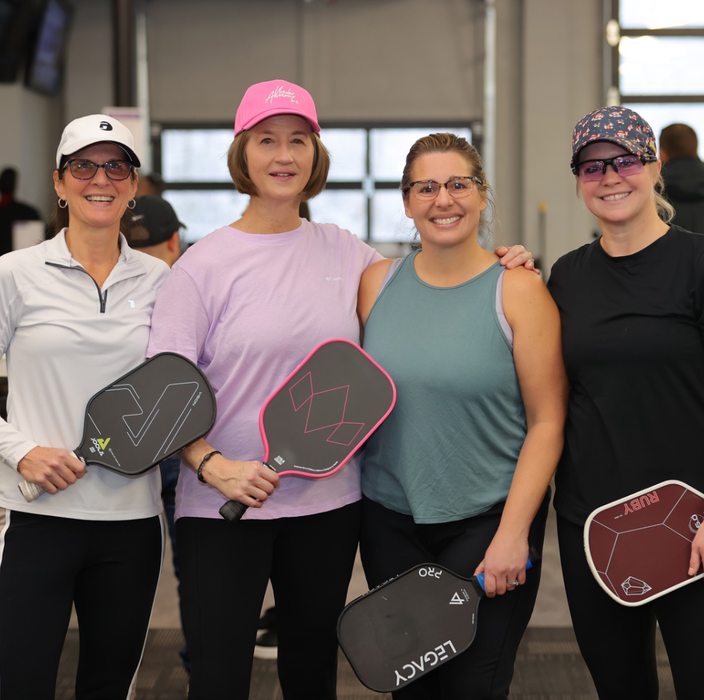 Four friends pose for the camera at Ascent Pickleball.